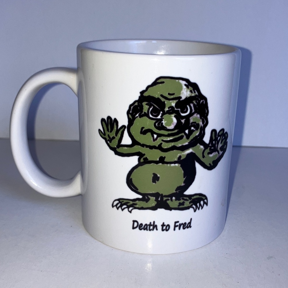White Mug with Green Cartoon Monster Character “Death‎ to Fred”